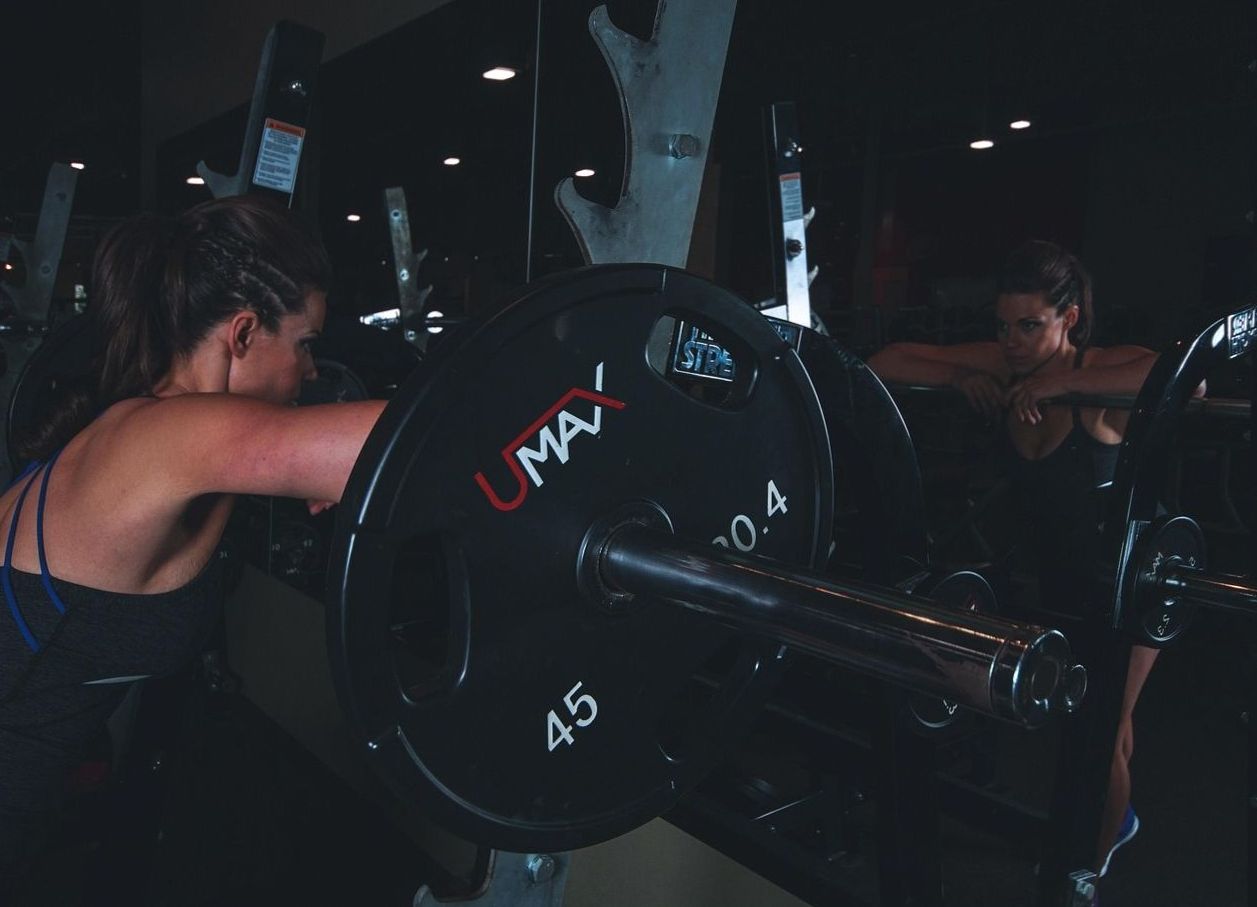 Personal trainer spotting a bench press